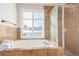 Spa-like bathroom with soaking tub, shower, and window at 4460 S Himalaya Ct, Aurora, CO 80015