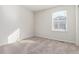 Bright and airy bedroom with neutral carpeting and a large window at 4460 S Himalaya Ct, Aurora, CO 80015