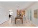 Bright dining room features a table with four chairs, and an open concept to the kitchen at 4460 S Himalaya Ct, Aurora, CO 80015