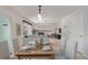 Dining area with a table set for four, and views into the living room at 4460 S Himalaya Ct, Aurora, CO 80015