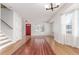 Entryway with hardwood floors, red front door, and staircase leading upstairs at 4460 S Himalaya Ct, Aurora, CO 80015