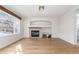 Living room with a fireplace and built-in shelving at 4460 S Himalaya Ct, Aurora, CO 80015