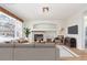 Living room featuring a cozy fireplace and ample natural light at 4460 S Himalaya Ct, Aurora, CO 80015