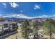 An aerial view of a property with nearby homes, trees, and a mountain range in the background at 2938 Kalmia Ave # 27, Boulder, CO 80301