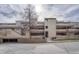 Modern multi-story condo building with visible balconies and a covered parking area at 2938 Kalmia Ave # 27, Boulder, CO 80301