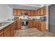 Well-lit kitchen featuring wood cabinets and modern stainless steel appliances at 2938 Kalmia Ave # 27, Boulder, CO 80301