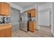 A well-lit kitchen with stainless steel refrigerator and wood cabinets with modern appliances on the counter at 2938 Kalmia Ave # 27, Boulder, CO 80301