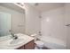 Bathroom featuring vanity with sink, toilet, and shower/tub combo with white tiling at 3033 W 107Th Pl # D, Westminster, CO 80031