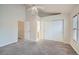 Bedroom boasts vaulted ceilings, neutral walls, plush carpet, and a view into ensuite bathroom at 3033 W 107Th Pl # D, Westminster, CO 80031