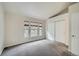 Spacious bedroom with plush carpet, three windows, and ample closet space at 3033 W 107Th Pl # D, Westminster, CO 80031