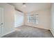 Bright bedroom featuring neutral walls, vaulted ceilings, plush carpet, and closet space at 3033 W 107Th Pl # D, Westminster, CO 80031