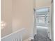 Well-lit hallway leading to a bedroom with plush carpeting and a sunlit window at 3033 W 107Th Pl # D, Westminster, CO 80031
