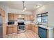 Well-lit kitchen featuring stainless steel appliances, ample counter space, and light wood cabinets at 3033 W 107Th Pl # D, Westminster, CO 80031