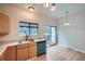 Kitchen with stainless steel sink, and sliding door, with modern appliances and fixtures at 3033 W 107Th Pl # D, Westminster, CO 80031