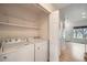 Convenient laundry room with washer, dryer, shelving and hardwood floors at 3033 W 107Th Pl # D, Westminster, CO 80031