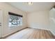 Bright living room with a large window and hardwood floors, next to the stairway at 3033 W 107Th Pl # D, Westminster, CO 80031
