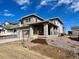 Stylish two-story house boasting a covered porch, neutral-toned siding, stone detailing and professional landscaping at 3996 N Irvington St, Aurora, CO 80019