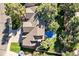 Aerial view of the home's roof, yard, and patio area surrounded by mature trees on a sunny day at 5344 E Otero Dr, Centennial, CO 80122