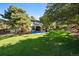 Lush green backyard with mature trees offering shade and privacy to the property at 5344 E Otero Dr, Centennial, CO 80122
