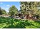 Beautifully landscaped backyard featuring a pool, patio area, and mature trees for shade at 5344 E Otero Dr, Centennial, CO 80122