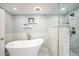 Bright and modern bathroom with a soaking tub, glass-enclosed shower, and stylish tile work at 5344 E Otero Dr, Centennial, CO 80122