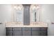Elegant bathroom featuring dual sinks, granite countertops, and decorative mirrors at 5344 E Otero Dr, Centennial, CO 80122