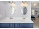 Bright bathroom featuring double sinks, large vanity, modern lighting and stylish fixtures at 5344 E Otero Dr, Centennial, CO 80122