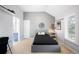Gray bedroom with slanted ceiling, white door, single bed and view of the bath at 5344 E Otero Dr, Centennial, CO 80122