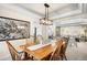 Elegant dining room with chandelier, hardwood table and view into the living room at 5344 E Otero Dr, Centennial, CO 80122