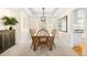 Traditional dining room with a wooden table, chairs, and view into the kitchen at 5344 E Otero Dr, Centennial, CO 80122