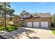 Charming two-story brick home with a well-manicured lawn, mature trees, and a three-car garage at 5344 E Otero Dr, Centennial, CO 80122