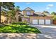 Charming two-story brick home with a well-manicured lawn, mature trees, and a three-car garage at 5344 E Otero Dr, Centennial, CO 80122