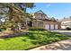 Charming brick home featuring a well-manicured lawn and a three-car garage at 5344 E Otero Dr, Centennial, CO 80122