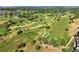 Scenic aerial view of a meticulously maintained golf course with lush greenery, ponds, and winding cart paths at 5344 E Otero Dr, Centennial, CO 80122