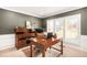 Well-lit home office featuring a wooden desk, ample storage, and a comfortable executive chair at 5344 E Otero Dr, Centennial, CO 80122