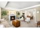 Elegant living room with fireplace, coffered ceiling, and open view to the dining area at 5344 E Otero Dr, Centennial, CO 80122