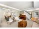 Open living space showcasing a piano, staircase, and seamless connection to the dining room at 5344 E Otero Dr, Centennial, CO 80122