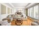 Spacious living room with hardwood floors, large windows, and view into the kitchen and dining area at 5344 E Otero Dr, Centennial, CO 80122