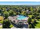 A community pool is surrounded by trees and offers a large deck with lounge chairs and a well-maintained recreation area at 5344 E Otero Dr, Centennial, CO 80122