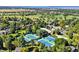 Aerial view of pristine tennis courts nestled within lush landscaping and mature trees in a beautiful community at 5344 E Otero Dr, Centennial, CO 80122