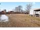 Exterior backyard featuring a fence, shed, and a spacious outdoor area for various activities at 635 2Nd St, Bennett, CO 80102