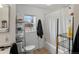 Clean bathroom featuring a bathtub, toilet, and storage shelving at 635 2Nd St, Bennett, CO 80102