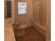 Bright bathroom features a shower-tub combo and a window providing natural light at 635 2Nd St, Bennett, CO 80102