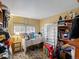 Bedroom with a large window, sewing machine on the desk, and shelves for storage at 635 2Nd St, Bennett, CO 80102