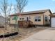 Charming single-story home with a cozy front porch and quaint decorative details at 635 2Nd St, Bennett, CO 80102