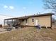 Tan house exterior with a covered patio and spacious backyard at 635 2Nd St, Bennett, CO 80102