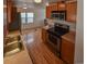 Efficient kitchen featuring stainless steel appliances and a dining area in the background at 635 2Nd St, Bennett, CO 80102