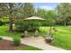 Secluded backyard setting with stone patio, comfortable seating, and mature landscaping for outdoor enjoyment at 1122 Forest Trails Dr, Castle Pines, CO 80108