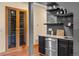 Entertaining bar area with wine storage, shelving, and beverage center at 1122 Forest Trails Dr, Castle Pines, CO 80108