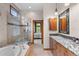 Elegant bathroom featuring a tub, walk-in shower, and granite vanity at 1122 Forest Trails Dr, Castle Pines, CO 80108